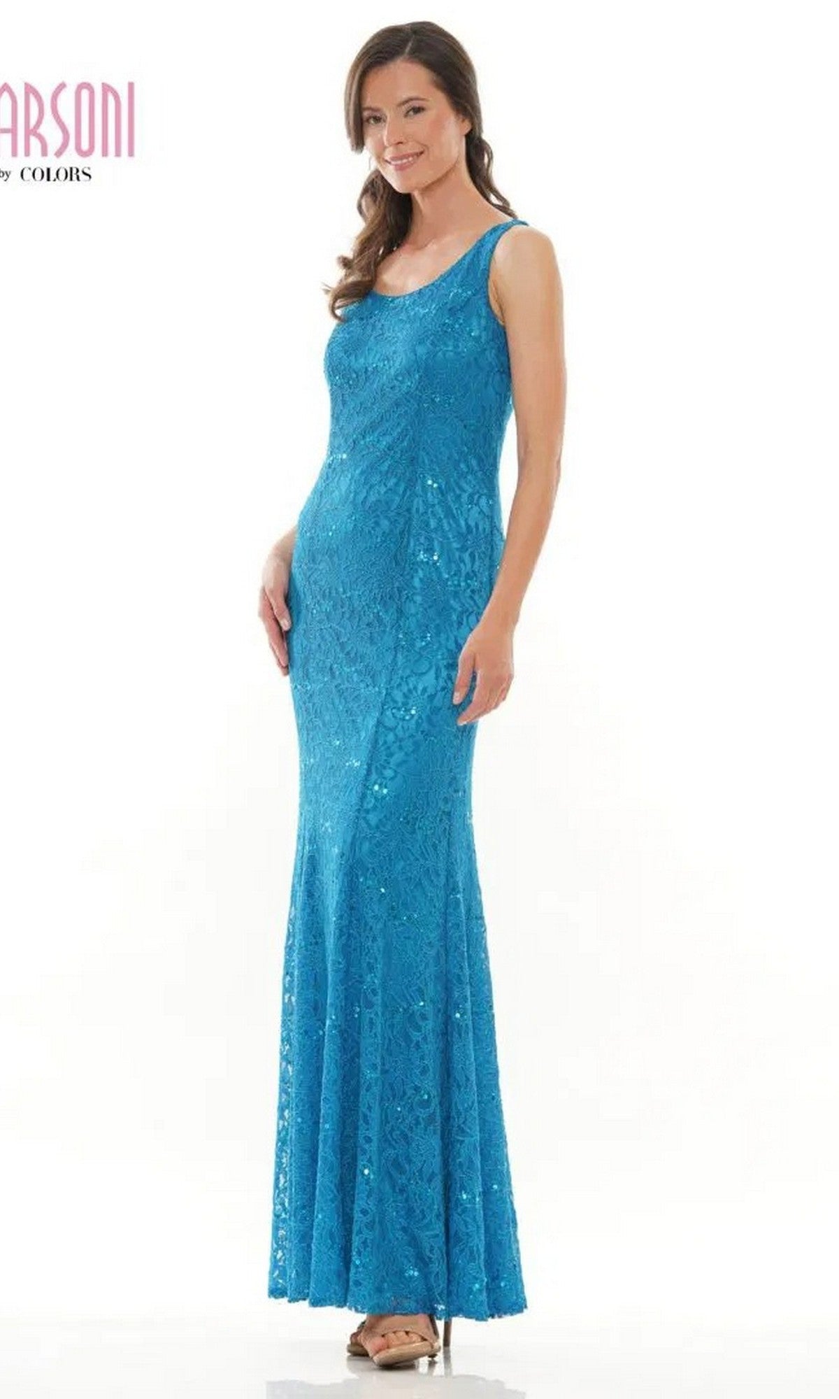 A woman wears the Marsoni M301 Long Formal Dress, a sleeveless, floor-length blue sequin gown with a fitted silhouette and subtle lace pattern, standing against a plain white background.